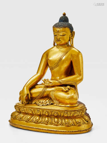 A GILT COPPER ALLOY FIGURE OF BUDDHA TIBET OR NEPAL, CIRCA 14TH CENTURY