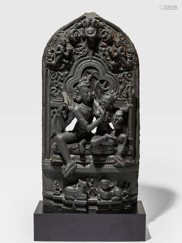 A BLACKSTONE STELE OF UMA MAHESHVARA ATTRIBUTED TO AMRITA (A.11TH/12TH CENTURY) BANGLADESH, PALA-SENA PERIOD, 11TH/12TH CENTURY