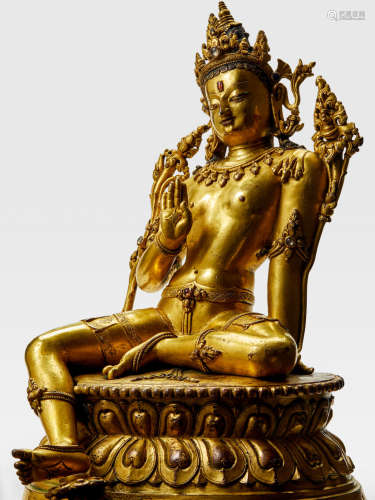 A GILT COPPER ALLOY FIGURE OF MAITREYA KHASA MALLA, 13TH/14TH CENTURY