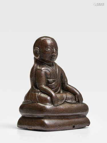 A SILVER INLAID COPPER ALLOY FIGURE OF A KAGYU LAMA TIBET, CIRCA 14TH CENTURY