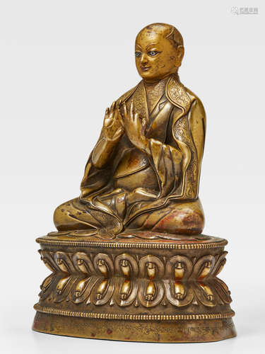 A SILVER AND COPPER INLAID BRASS FIGURE OF DRAKPA GYALTSEN TSANG, CENTRAL TIBET, 15TH CENTURY