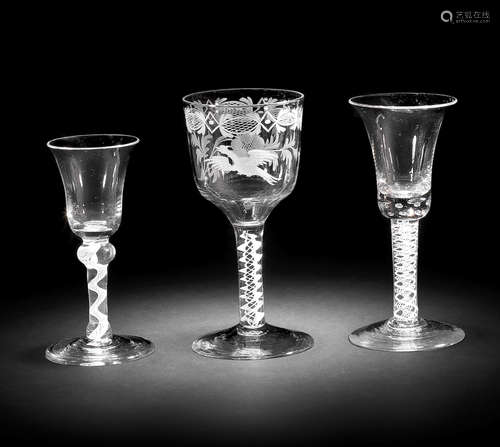 An engraved opaque twist goblet and two wine glasses, circa 1765