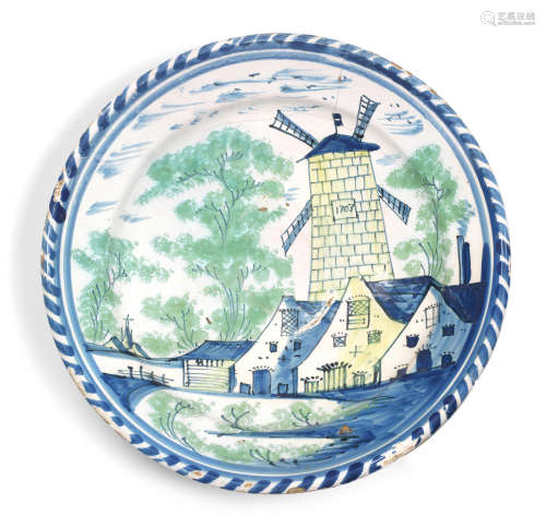 A very rare delftware charger, dated 1703