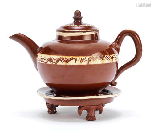 A rare Staffordshire glazed redware teapot, cover and stand, circa 1740-50