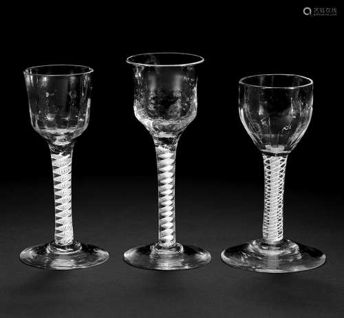 Three moulded opaque twist wine glasses, circa 1760-65