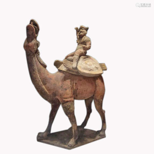 A Pottery Figure Of Man Riding Camel