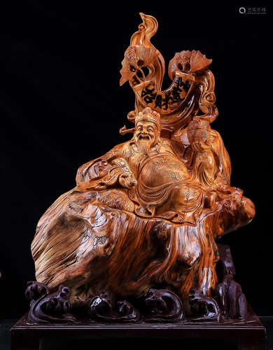 A YABAI WOOD CARVED CAISHEN BUDDHA ORNAMENT