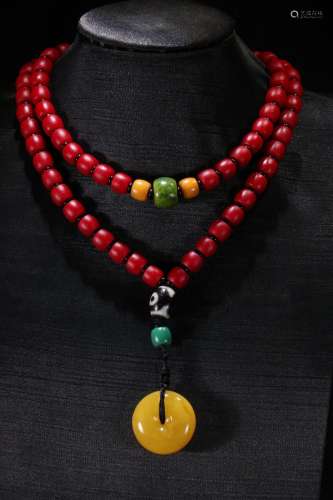 A Chinese Amber Pendant With Sherpa Glass Bead Necklace