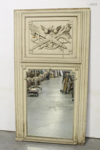An elaborately carved French door with mirror