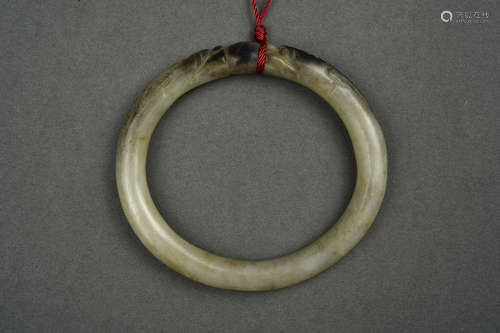 A WHITE AND RUSSET JADE BANGLE HAN DYNASTY