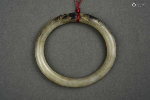 A WHITE AND RUSSET JADE BANGLE HAN DYNASTY