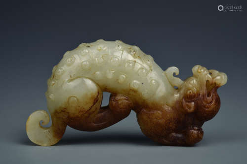 A WHITE AND RUSSET JADE DRAGON HAN DYNASTY