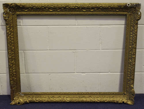 A large gilt composition Watts style picture frame, rebate 72cm x 92cm, together with two other gilt