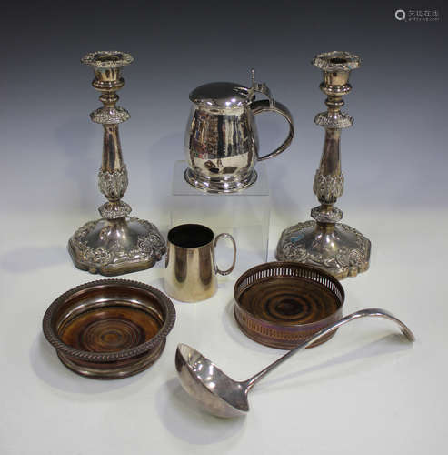 A pair of 19th century Sheffield plate candlesticks with foliate moulded nozzles, tapered stems