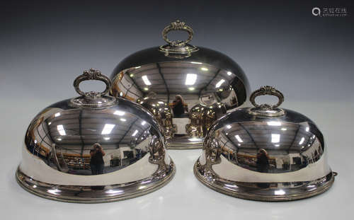 A graduated set of three early 20th century plated oval meat domes by Walker & Hall, each with