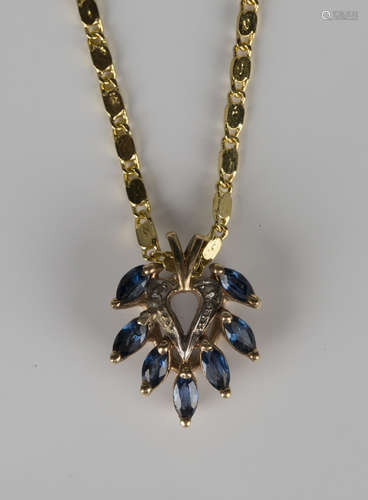 A 9ct gold and sapphire pendant of pierced heart shaped form, mounted with seven marquise shaped