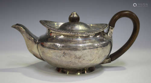 A George III silver teapot of squat circular form with gadrooned rim and hinged lid, London 1817,