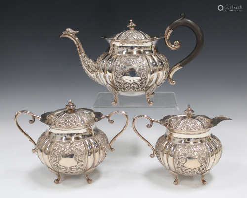 An Indian white metal three-piece tea set, comprising teapot, sugar bowl and cover and milk jug