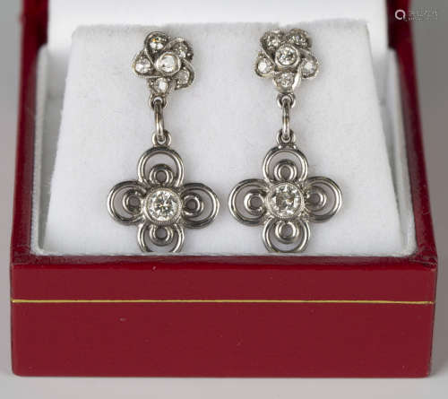 A pair of diamond pendant earrings, each drop collet set with a circular cut diamond within a