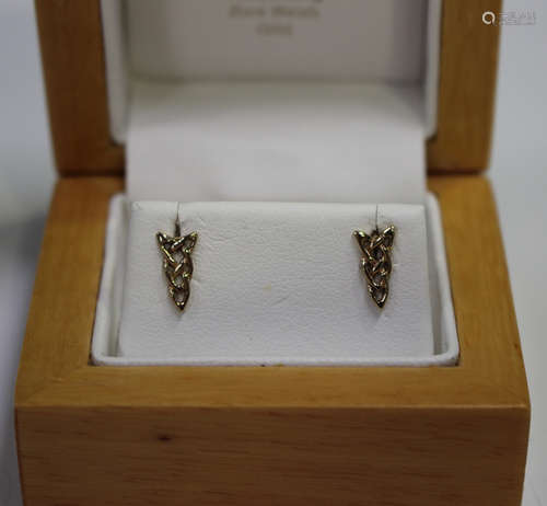 A pair of 9ct gold earstuds of pierced Celtic design, with post fittings and associated butterfly