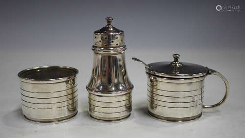 An Art Deco silver three-piece condiment set, comprising salt, pepper and mustard, each with