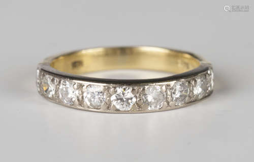 A gold and diamond nine stone half-hoop eternity ring, mounted with a row of circular cut