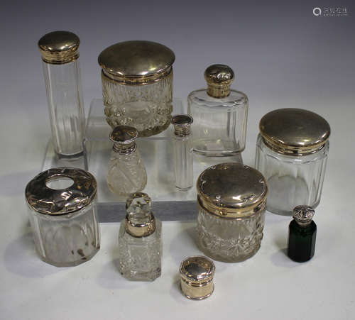 A group of silver topped glass bottles and toilet jars, various dates and makers.Buyer’s Premium