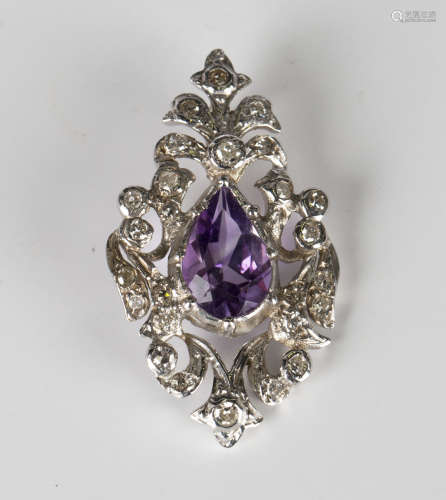 A white gold, amethyst and diamond pendant in a pierced openwork design, mounted with the pear