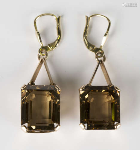 A pair of gold and smoky quartz pendant earrings, each drop claw set with a cut cornered rectangular