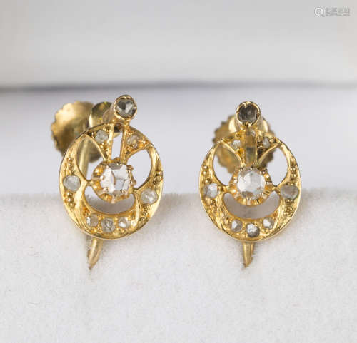 A pair of gold and rose cut diamond earrings, each in an oval openwork design, with screw