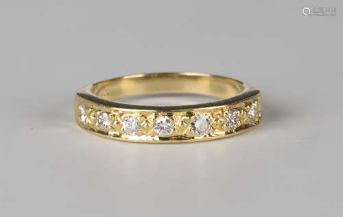 A gold and diamond seven stone half-hoop eternity ring, mounted with a row of circular cut diamonds,