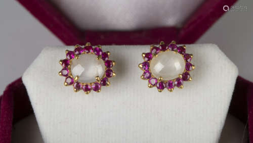 A pair of gold, moonstone and ruby cluster earstuds, each claw set with an oval moonstone within a