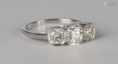 A platinum and diamond three stone ring, mounted with circular cut diamonds in octagonal settings