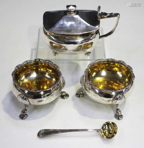A pair of George II silver circular salts, each with scalloped rim and gilt interior, on scallop