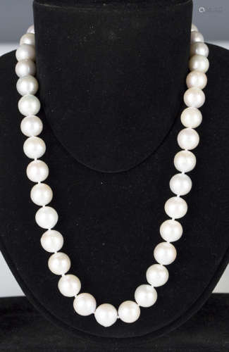 A single row necklace of slightly graduated South Sea cultured pearls on a silver gilt hook shaped