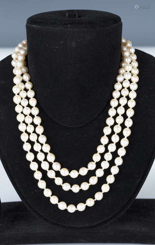 A three row necklace of cultured pearls on a 9ct gold, seed and cultured pearl set clasp, Birmingham