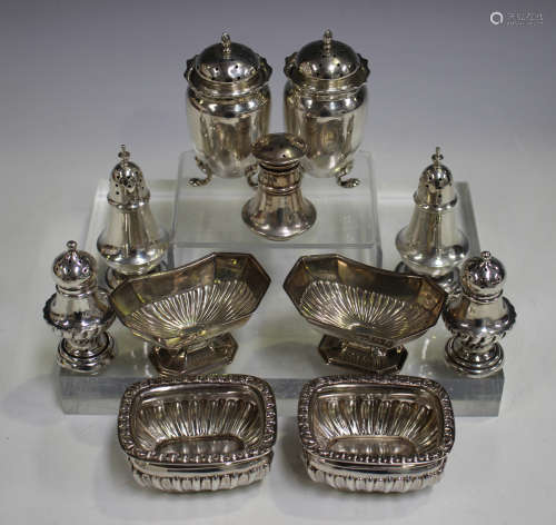 A group of assorted silver condiments, including a pair of George V pepper casters, Birmingham 1913,