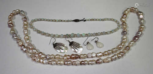 A single row necklace of graduated opal beads with faceted divisions at intervals, on a silver and