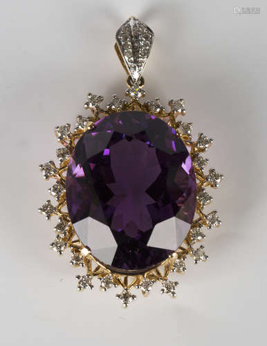 A gold, amethyst and diamond pendant, claw set with a large oval cut amethyst within a two row