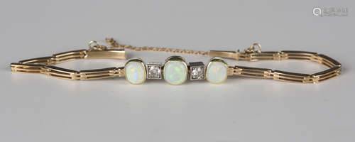 A gold, opal and diamond bracelet, the front collet set with three oval opals alternating with two