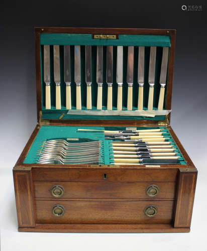 A George V canteen of silver St James pattern cutlery, comprising twelve bone handled table knives
