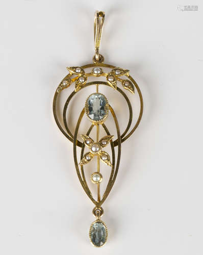 A gold, aquamarine and seed pearl pendant in a pierced openwork design with foliate motifs, detailed