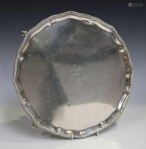 A George V silver salver with gadrooned rim and engraved crest, on claw and ball feet, Sheffield