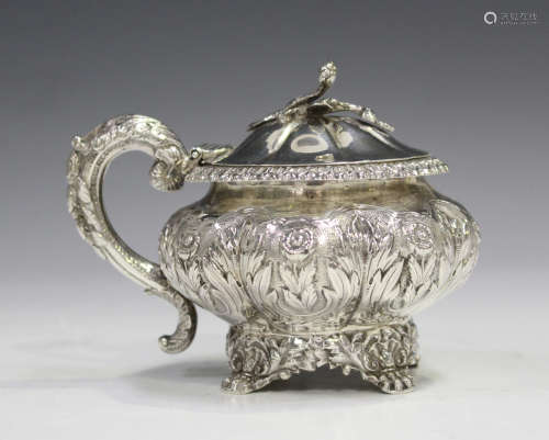 A George IV silver mustard of lobed squat form, repoussé decorated with flower and leaf band, the