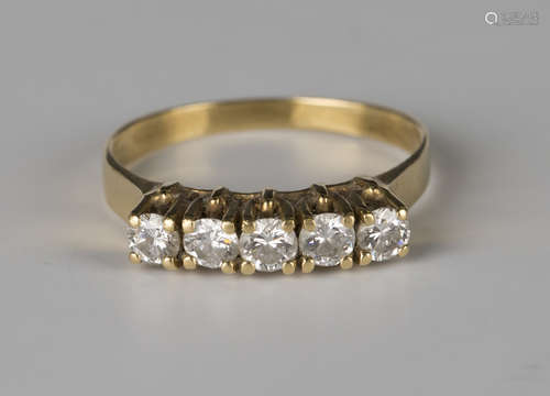 A gold and diamond five stone ring, mounted with a row of circular cut diamonds, detailed '750',