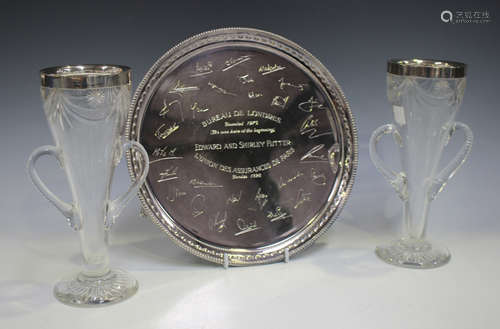 An Elizabeth II silver circular salver with engraved presentation inscription within a bellflower