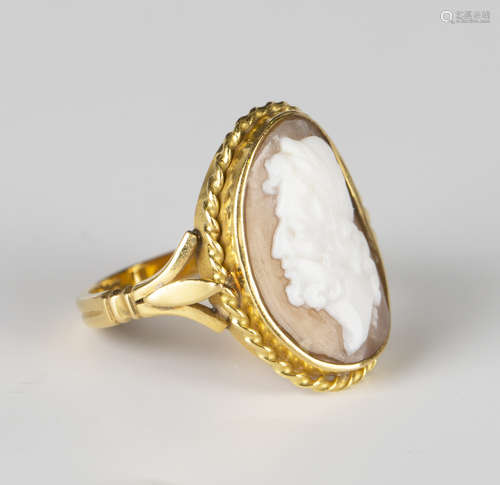 A gold and oval shell cameo ring, carved as a portrait of a bearded classical gentleman within a