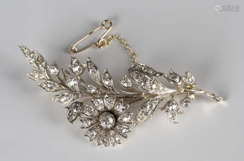 A late Victorian gold backed and silver set diamond brooch, circa 1900, designed as a curved