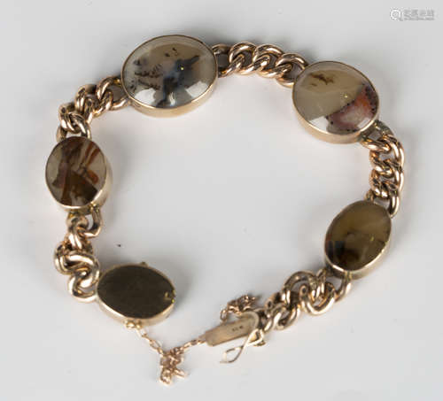 A gold and vari-coloured oval agate curblink bracelet on an oval clasp, detailed '9ct', fitted