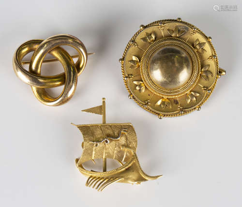 A gold brooch in a trefoil design, width 2.7cm, a Victorian locket brooch of circular form,